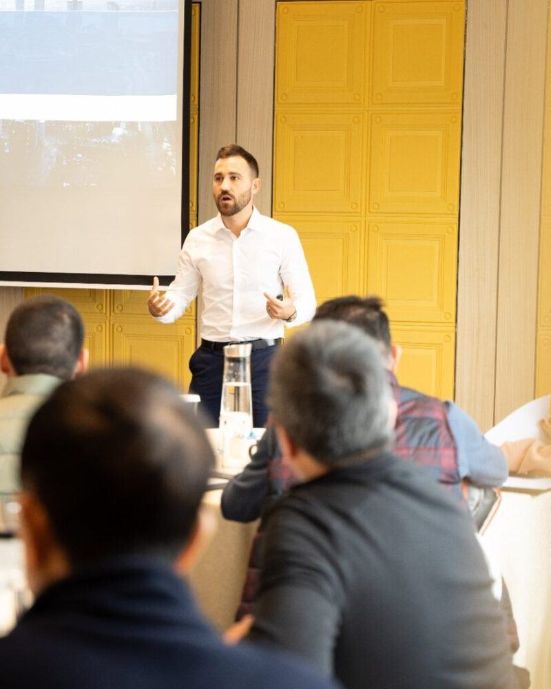 Tobi Mancuso, Director, presenting to investors